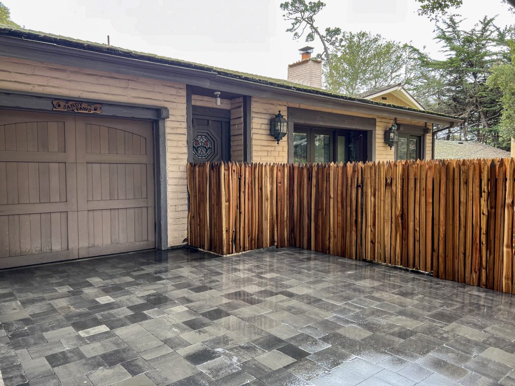 Wood privacy fence installation with paver driveway in Monterey County residential property