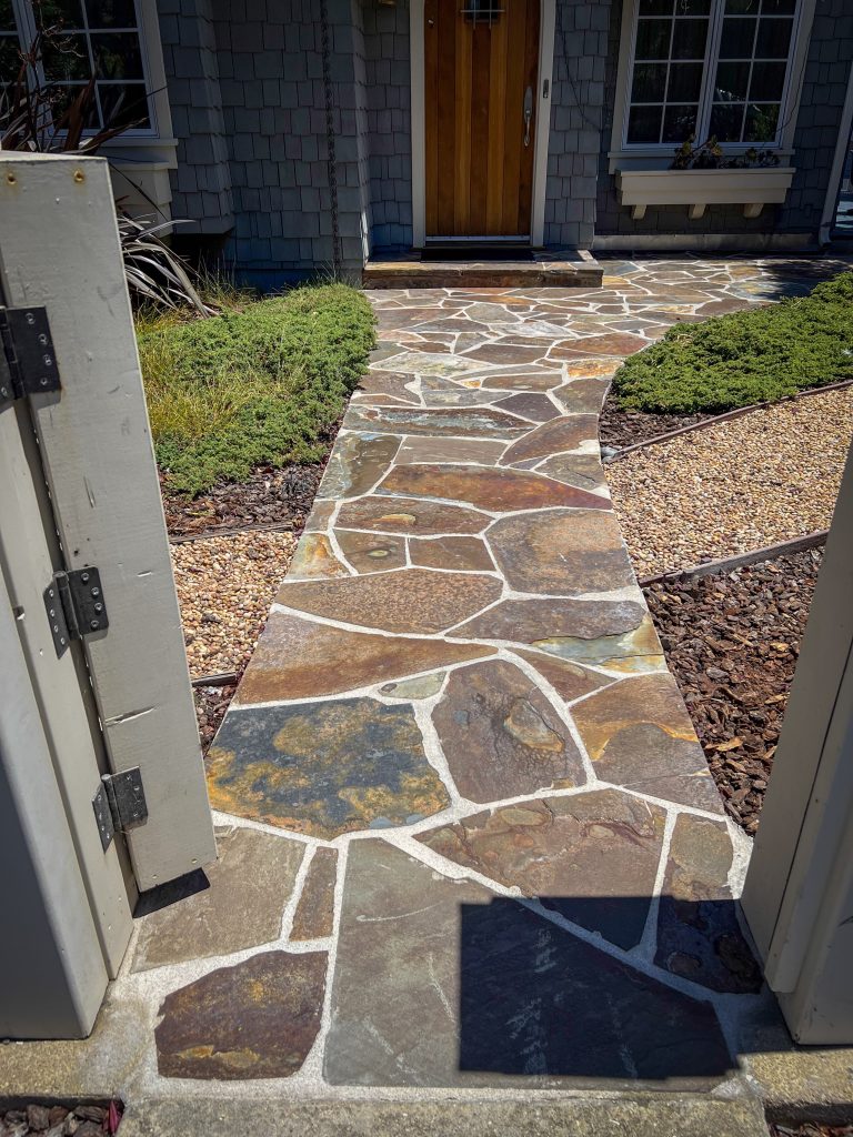 Reconstructed flagstone walkway showcasing detailed stonework and craftsmanship in a Monterey County home