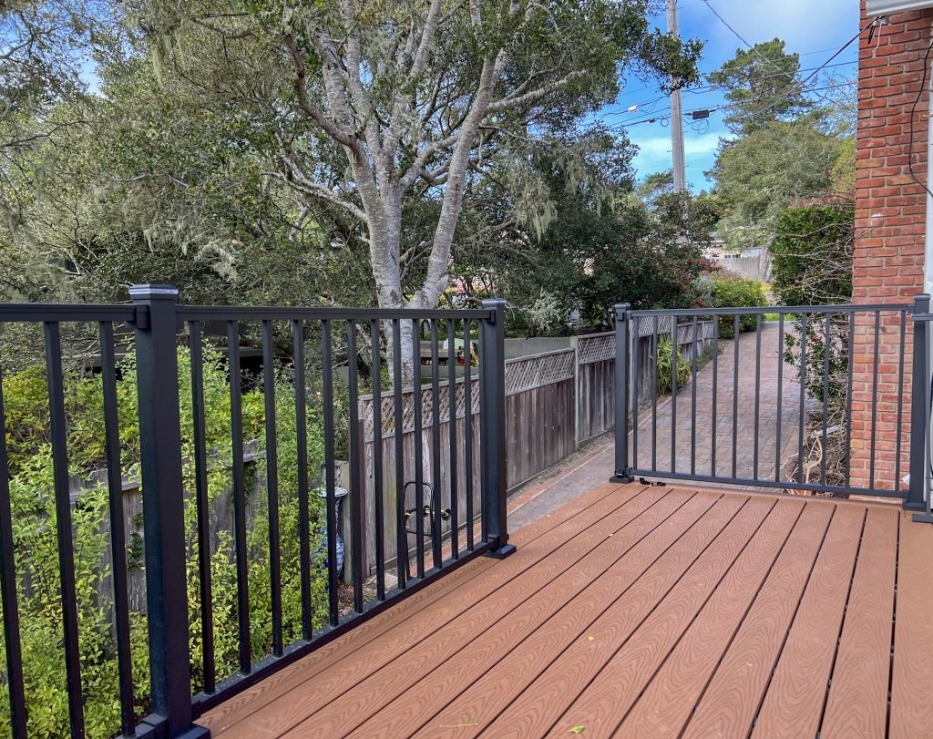 Trex composite deck installation with black aluminum railing at Monterey coastal home